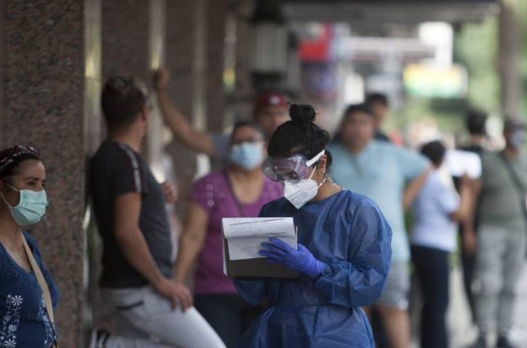 A nurse takes notes of personal information of people who will be tested for COVID-19 during the beginning of a public testing program in Monterrey, Nuevo Leon, Mexico, on April 09, 2020. (Photo by Julio Cesar AGUILAR / AFP)
