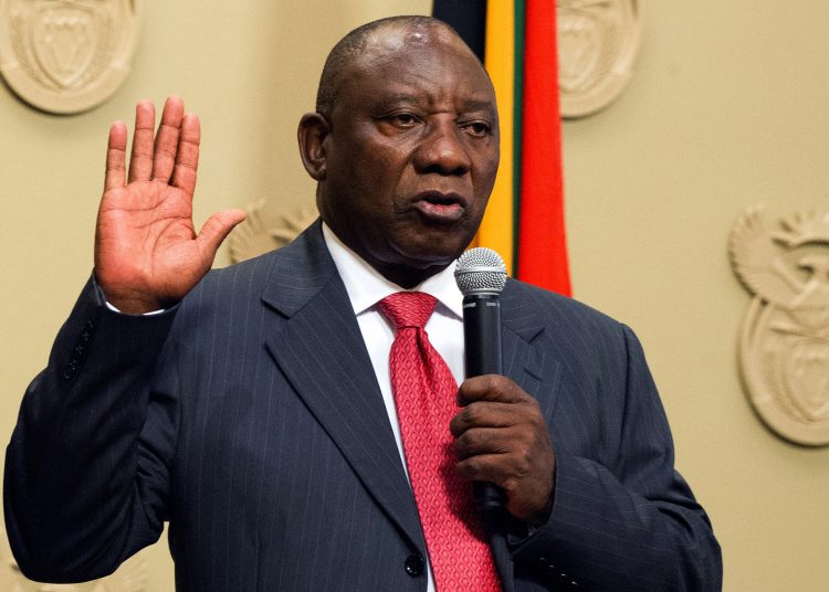 South Africa's new president Cyril Ramaphosa holds up his right hand as he is sworn into office  after being elected by the Members of Parliament at the Parliament in Cape Town, on February 15, 2018.

South African lawmakers elected wealthy former businessman Cyril Ramaphosa on February 15, 2018 as the country's new president after scandal-tainted Jacob Zuma resigned under pressure from his own ANC ruling party. Ramaphosa was elected without a vote after being the only candidate nominated in the parliament in Cape Town, chief justice Mogoeng Mogoeng told assembled lawmakers.
 / AFP PHOTO / POOL / Rodger BOSCH
