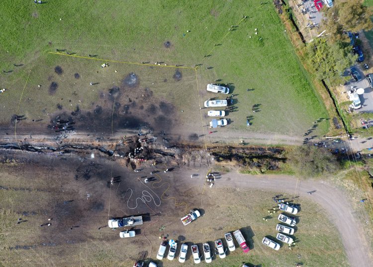 The ground is scorched where an oil pipeline exploded in Tlahuelilpan, Hidalgo state, Mexico, Saturday, Jan. 19, 2019. A massive fireball that engulfed people scooping up fuel spilling from a pipeline ruptured by thieves in central Mexico killed dozens of people and badly burned many more.  (AP Photo/Alexis Triboulard)