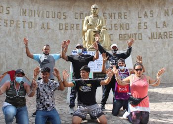 Migrantes se encadenan para exigir entrega de documentos