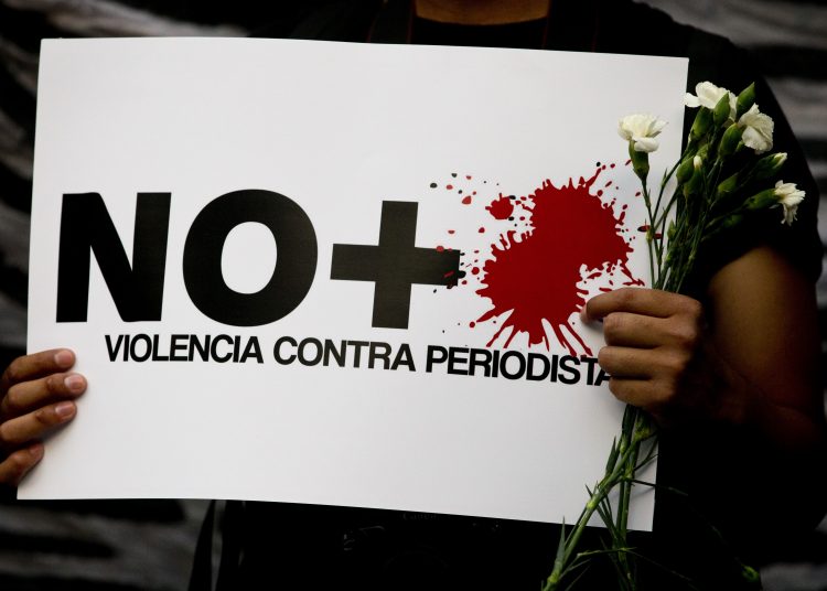 A protestor holds a sign reading "No more violence against journalists," during a demonstration outside the Interior Ministry in Mexico City, Tuesday, May 16, 2017. On Monday Javier Valdez, a veteran reporter who specialized in covering drug trafficking and organized crime, was slain Monday in the northern Mexico state of Sinaloa, the latest in a wave of journalist killings in one of the world's most dangerous countries for media workers. (AP Photo/Rebecca Blackwell)