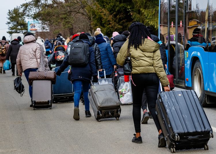 Uzhhorod, Ukraine - February 26, 2022: Ukrainian refugees with things rush to the Slovak border fleeing Russian aggression against Ukraine.