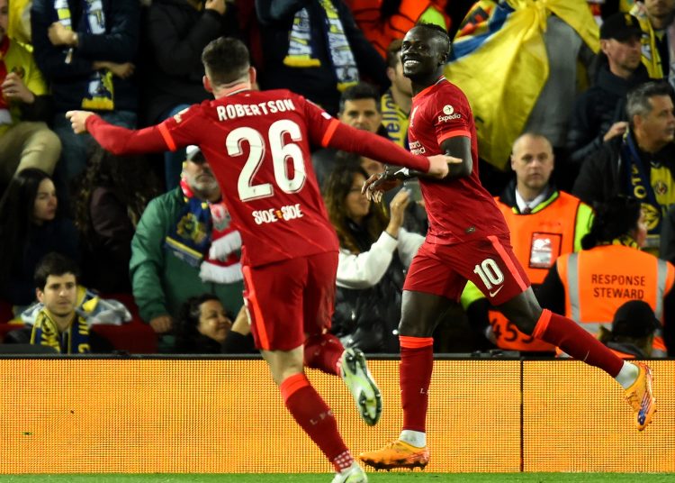 Liverpool (United Kingdom), 27/04/2022.- Liverpool's Sadio Mane (R) celebrates with teammate Andrew Robertson (L) after scoring the 2-0 goal during the UEFA Champions League semi final, first leg soccer match between Liverpool FC and Villarreal CF in Liverpool, Britain, 27 April 2022. (Liga de Campeones, Reino Unido) EFE/EPA/PETER POWELL