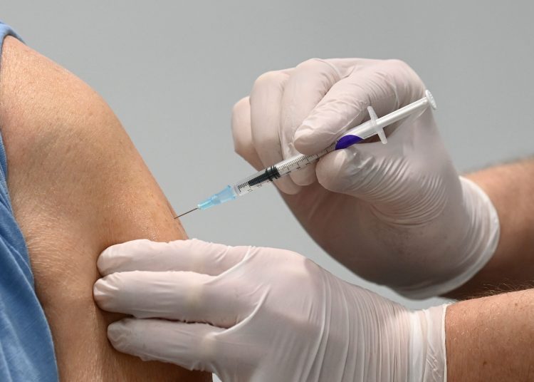(FILES) In this file photo taken on March 18, 2021 a man receives the Pfizer-BioNTech COVID-19 Vaccine at a vaccination center in Nuremberg, southern Germany, amid the ongoing coronavirus (Covid-19) pandemic. - Germany is expecting to open up Covid-19 vaccinations to all adults in June at the latest, German Health Minister Jens Spahn said on April 22, 2021. Spahn is hoping "that we will be able to lift the prioritisation in June", he told the Bundesrat upper house of parliament, referring to current lists deciding who gets the jabs first. He added that the move may be possible even earlier. (Photo by Christof STACHE / AFP)