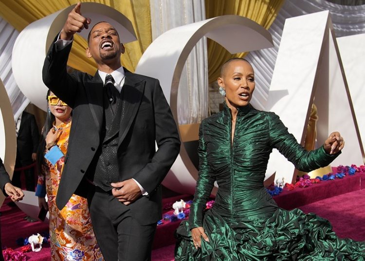 Will Smith, left, and Jada Pinkett Smith arrive at the Oscars on Sunday, March 27, 2022, at the Dolby Theatre in Los Angeles. (AP Photo/John Locher)