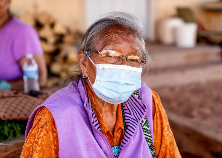 Aged Grandmother Navajo Woman Wearing a Mask to Prevent the Spread of the Corona Virus or Covi-19
