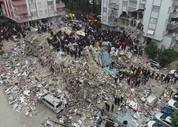 People search through rubble following an earthquake in Adana, Turkey February 6, 2023. Ihlas News Agency (IHA) via REUTERS ATTENTION EDITORS - THIS PICTURE WAS PROVIDED BY A THIRD PARTY. NO RESALES. NO ARCHIVES. TURKEY OUT. NO COMMERCIAL OR EDITORIAL SALES IN TURKEY.