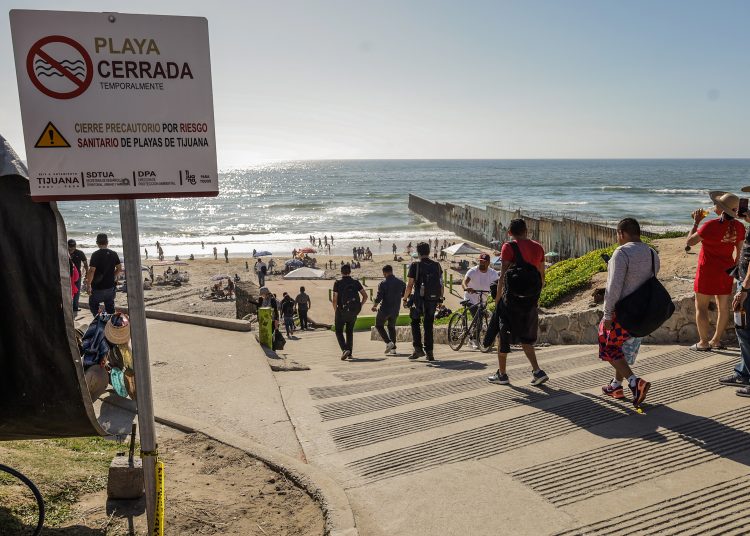 MEX1799.TIJUANA (MÉXICO), 09/04/2023.- Visitantes disfrutan de la playa pese a las restricciones por la alta contaminación el 8 de abril de 2023, en la ciudad de Tijuana, Baja California (México). Cientos de vacacionistas asistieron este fin de semana a las playas de la fronteriza ciudad mexicana de Tijuana, pese a los señalamientos de las autoridades y las advertencias de activistas ambientalistas sobre los altos índices de contaminación en el mar. EFE/Joebeth Terriquez