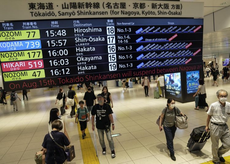 Tokyo (Japan), 14/08/2023.- People walk under a display board showing the bullet train departure times and suspension of services at Tokyo railway station in Tokyo, Japan, 14 August 2023. As the powerful typhoon Lan approaches western Japan, the Central Japan Railway Company and West Japan Railway Company announced the suspension of its Tokaido and Sanyo Shinkansen bullet train service between Nagoya and Shin-Osaka, and between Shin-Osaka and Okayama in western Japan from 15 August. (Japón, Tokio) EFE/EPA/KIMIMASA MAYAMA