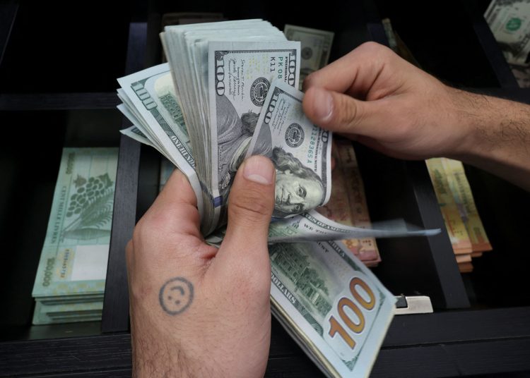 A money exchange vendor counts U.S. dollar banknotes at a shop in Beirut, Lebanon March 10, 2023. REUTERS/Mohamed Azakir