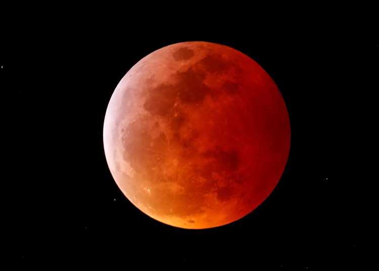 FILE PHOTO: A total lunar eclipse that is called a 'Super Blood Wolf Moon' is seen from Encinitas, California, U.S., January 20, 2019.  REUTERS/Mike Blake/File Photo