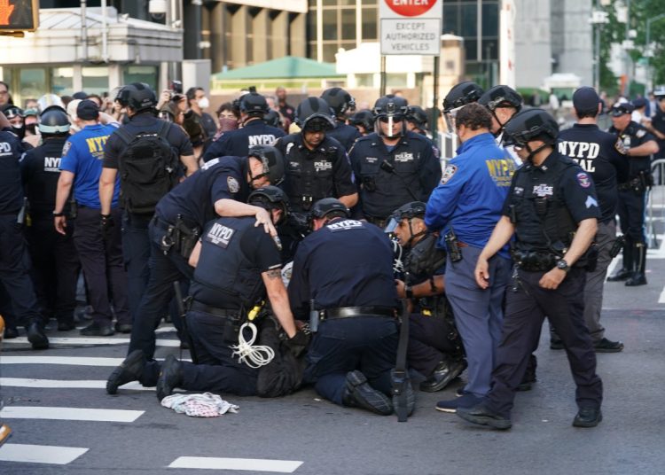 NYPD officers detain a demonstrator during an "ICE Out Of NYC" protest against US Immigration and Customs Enforcement (ICE) and federal immigration operations, in New York City on June 10, 2025. The protest in New York and other cities comes in the wake of demonstrations triggered in Los Angeles, home to millions of foreign-born and Latino residents, after an intensification of US President Donald Trump's signature campaign to deport illegal migrants. (Photo by DAVID DEE DELGADO / AFP)