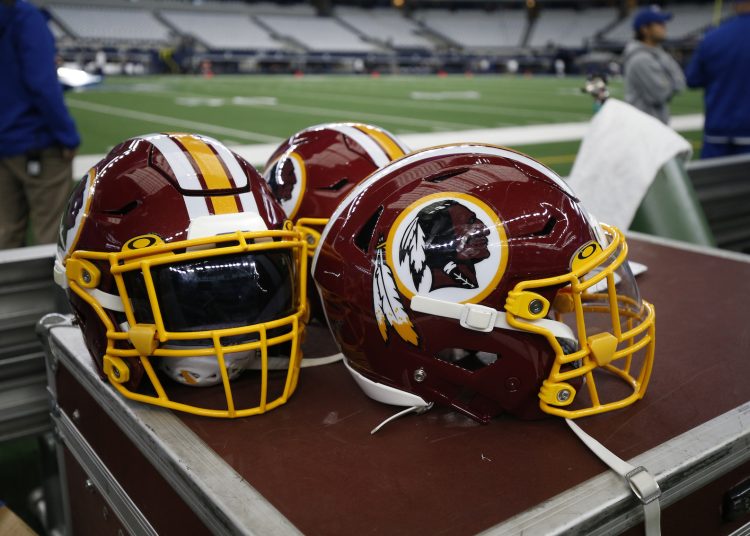 Washington Redskins helmets are seen on the sideline before an NFL football game between the Dallas Cowboys and the Washington Redskins in Arlington, Texas, Sunday, Dec. 15, 2019. (AP Photo/Michael Ainsworth)