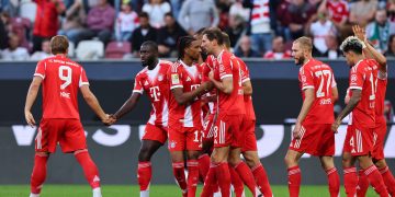 Michael Olise of Bayern Munich (C) celebrates with teammates after scoring the 0-3 goal during the German Bundesliga