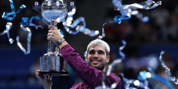 Carlos Alcaraz of Spain poses with his trophy after winning the final match against Taylor
