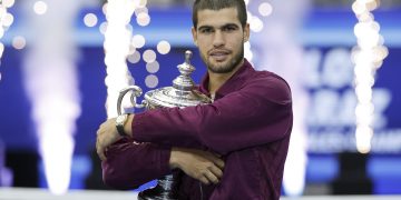 Carlos Alcaraz of Spain poses with the Champions trophy