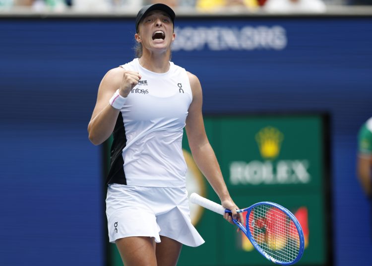 Iga Swiatek of Poland gestures after winning match point against