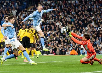 Erling Haaland of Manchester City (C) and goalkeeper Gregor Kobel of Borussia