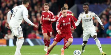 Liverpool in action against Federico Valverde (L) and Eduardo Camavinga of Real Madrid during the UEFA Champions League