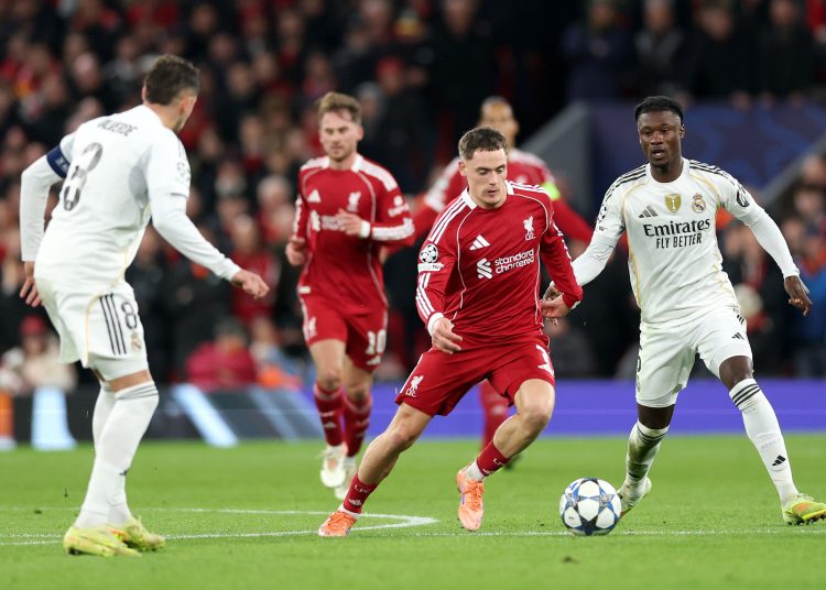 Liverpool in action against Federico Valverde (L) and Eduardo Camavinga of Real Madrid during the UEFA Champions League
