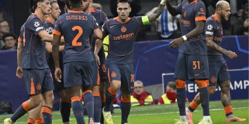 Inter Milan’s Lautaro Martinez (C) celebrates with teammates after scoring the 1-0