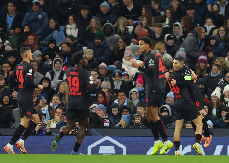 Leverkusen Alejandro Grimaldo (R) celebrates with teammates after s