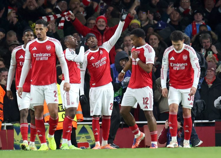 Arsenal celebrates with teammates after scoring his team's second goal during the UEFA Champions League