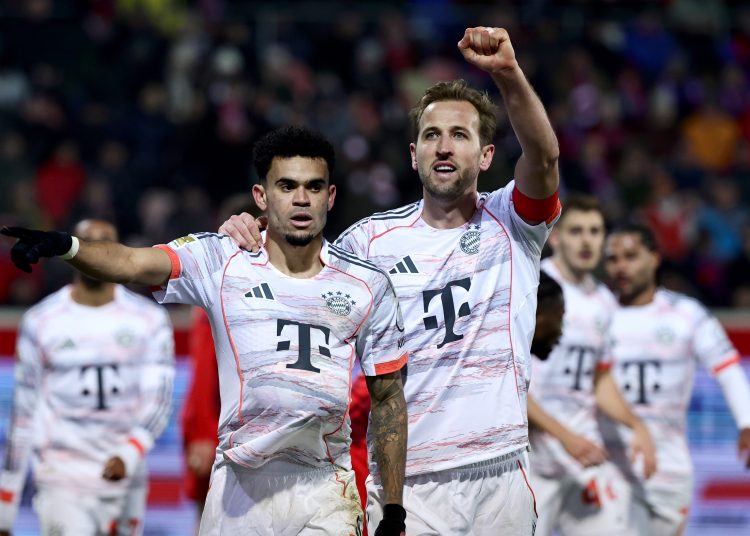 Luis Diaz of Bayern Munich (L) celebrates with teammate Harry Kane after scoring the 0-3 goal during the German