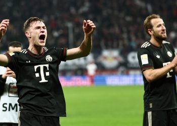 Harry Kane (R) and Joshua Kimmich of Bayern Munich greet their supporters after winning the German Bundesliga