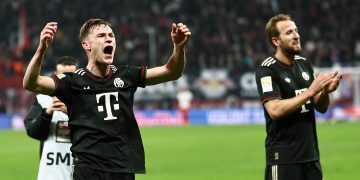 Harry Kane (R) and Joshua Kimmich of Bayern Munich greet their supporters after winning the German Bundesliga