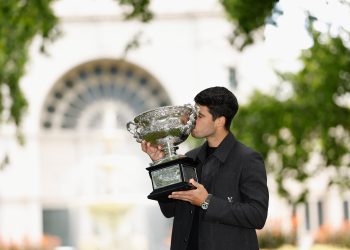 Carlos Alcaraz poses for a photograph after winning the AO 2026 men’s singles final against Novak Djokovic