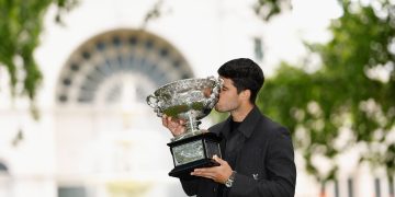 Carlos Alcaraz poses for a photograph after winning the AO 2026 men’s singles final against Novak Djokovic