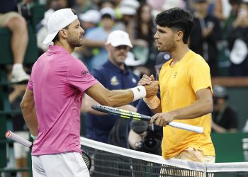 Carlos Alcaraz of Spain (R) greets Grigor Dimitrov of Bulgaria (L) at the net after Alcaraz