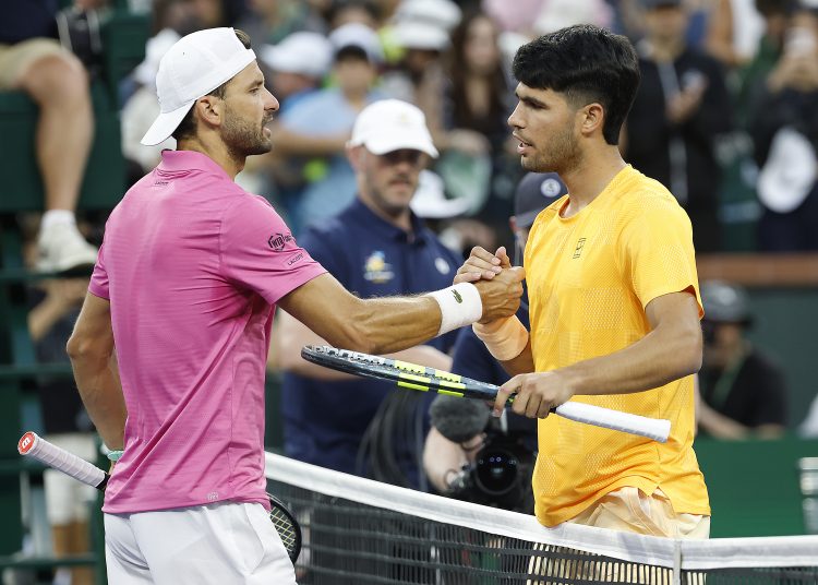Carlos Alcaraz of Spain (R) greets Grigor Dimitrov of Bulgaria (L) at the net after Alcaraz