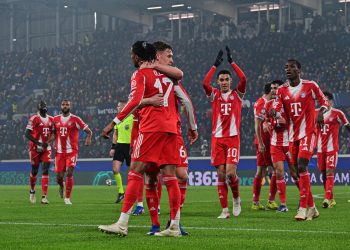 Bayern Munich's Michael Olise (L) celebrates with teammates after scoring a goal during the UEFA