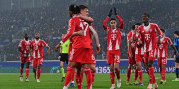 Bayern Munich's Michael Olise (L) celebrates with teammates after scoring a goal during the UEFA