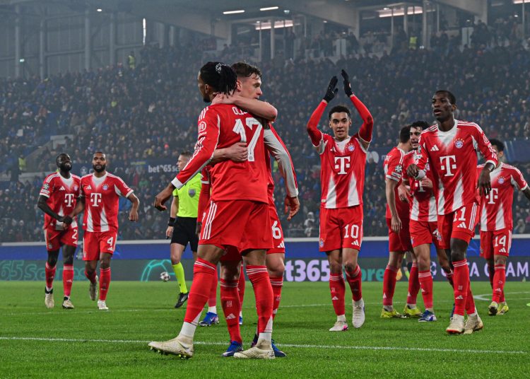 Bayern Munich's Michael Olise (L) celebrates with teammates after scoring a goal during the UEFA