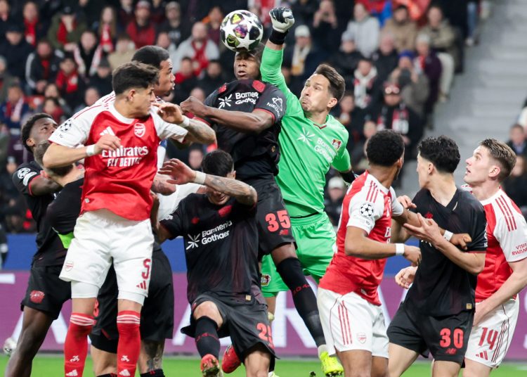 Goalkeeper Janis Blaswich of Bayer Leverkusen (C-R) makes a save during the UEFA Champions League