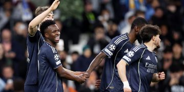 Vinicius Junior (L) of Real Madrid celebrates with teammates after scoring his second goal during the UEFA