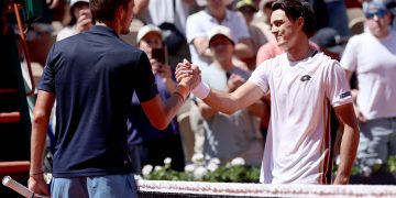 Adam Walton (R) of Australia is congratulated at the net by Daniil Medvedev of Russia after he won their Men's 1st round match at the French Open Grand Slam