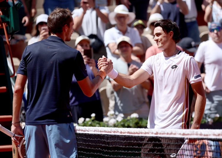 Adam Walton (R) of Australia is congratulated at the net by Daniil Medvedev of Russia after he won their Men's 1st round match at the French Open Grand Slam