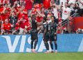 Canada forward Jonathan David (C) celebrates with teammates Cyle Larin (L) and Tajon Buchanan