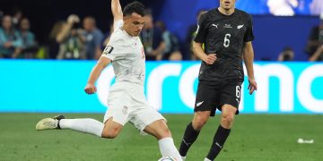 Amirhossein Hosseinzadeh (i) de Irán disputa un balón con Joe Bell de Nueva Zelanda